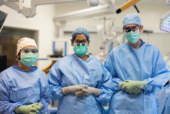 Surgeon looking through a microscope