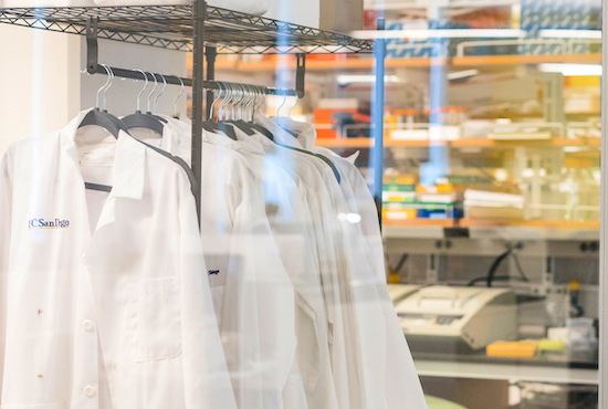 lab coats on a rack